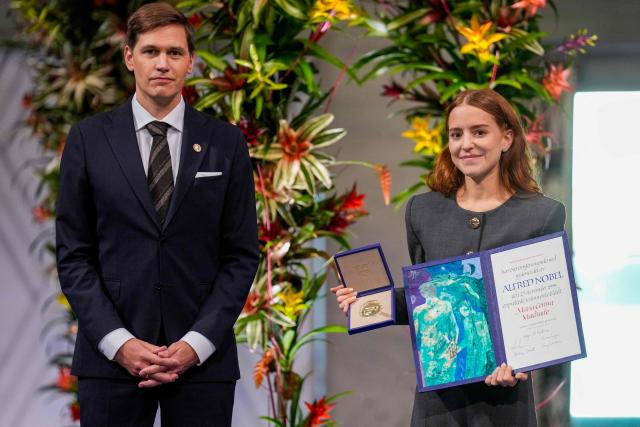 Ana Corina Sosa (R), daughter of Venezuelan opposition leader Maria Corina Machado, receives the Nobel Peace Prize for her mother from the Chair of the Norwegian Nobel Committee Jorgen Watne Frydnes (L) at the Nobel Peace Prize ceremony at Oslo City Hall on December 10, 2025 in Oslo, Norway. The 2025 Nobel Peace Prize was awarded to Machado for her efforts to bring democracy to Venezuela, challenging the iron-fisted rule of Venezuelan President Nicolas Maduro, who has been president since 2013. (Photo by Ole Berg-Rusten / NTB / AFP) / Norway OUT