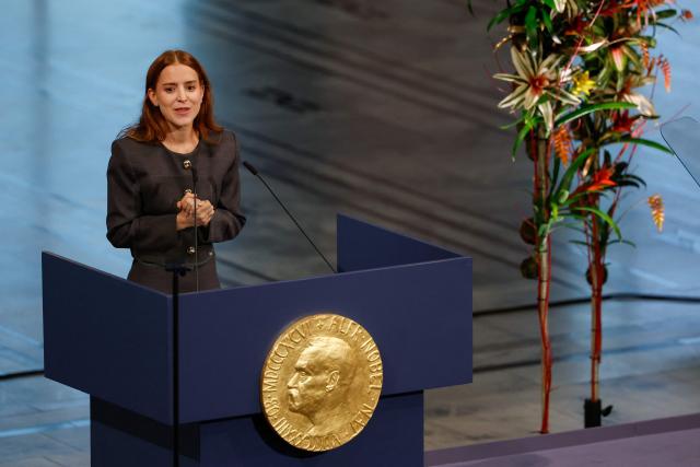 Ana Corina Sosa, daughter of Venezuelan opposition leader Maria Corina Machado, speaks after receiving the Nobel Peace Prize for her mother at the Nobel Peace Prize ceremony at Oslo City Hall on December 10, 2025 in Oslo, Norway. The 2025 Nobel Peace Prize was awarded to Machado for her efforts to bring democracy to Venezuela, challenging the iron-fisted rule of Venezuelan President Nicolas Maduro, who has been president since 2013. (Photo by Odd ANDERSEN / AFP)
