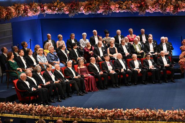 From left, Nobel Prize in Physics 2025 laureates British physicist John Clarke, Michel H Devoret and John M. Martinis, Nobel Prize in Chemistry 2025 laureates Japanese chemist Susumu Kitagawa, Richard Robson and Omar M Yaghi, Nobel Prize in Physiology or Medicine laureates Mary E Brunkow, Fred Ramsdell and Shimon Sakaguchi, Nobel Prize in Literature laureates Laszlo Krasznahorkai, Nobel Prize in Economics laureates Joel Mokyr, Philippe Aghion and Peter Howitt at the Nobel Prize ceremony attend the Nobel Prize award ceremony at the Concert Hall in Stockholm, Sweden, on December 10, 2025. The laureates will receive their prizes at formal ceremonies in Stockholm and Oslo on December 10. That date is the anniversary of the death in 1896 of scientist Alfred Nobel, who created the prizes in his will. (Photo by Jonathan Nackstrand / AFP)