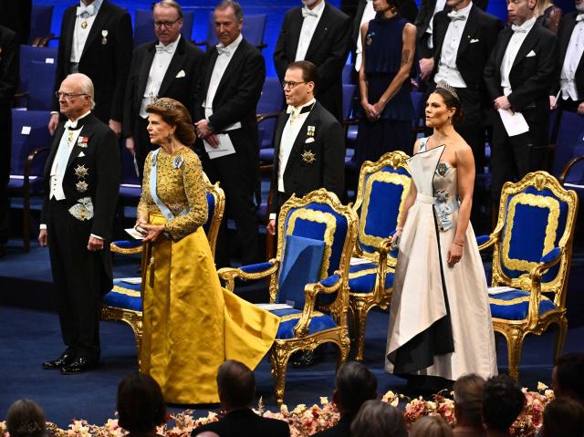 (L-R) Sweden's King Carl Gustaf, Queen Silvia, Prince Daniel and Crown Princess Victoria attend  the 2025 Nobel Prize ceremony at the Concert Hall in Stockholm, Sweden, December 10, 2025. The laureates received their prizes at formal ceremonies in Stockholm and Oslo on December 10. That date is the anniversary of the death in 1896 of scientist Alfred Nobel, who created the prizes in his will. (Photo by Anders WIKLUND / TT News Agency / AFP) / Sweden OUT