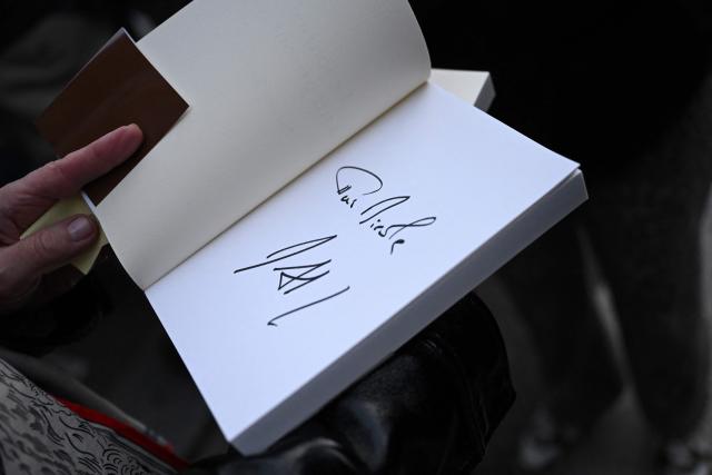 This photograph shows the signature of France's former President Nicolas Sarkozy in one copy of his book "Diary of a Prisoner" on the day of its' release at the Lamartine bookshop in Paris on December 10, 2025. Sarkozy has written a 216-page book entitled "Diary of a Prisoner," released on December 10, 2025 and excerpts of which were published in several French media on December 6, 2025. Nicolas Sarkozy, who was president from 2007 to 2012, was protected in prison by two security officers and remained confined to his cell 23 hours a day, except for visiting hours. (Photo by Bertrand GUAY / AFP)
