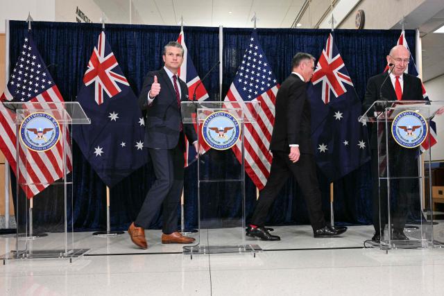 (L/R) US Secretary of Defense Pete Hegseth gives a thumbs up as he departs alongside Australian Deputy Prime Minister and Defense Minister Richard Marles, and Britain's Defence Secretary John Healey after they delivered remarks during the annual AUKUS Defense Ministers' Ministerial at the Pentagon in Washington, DC, on December 10, 2025. (Photo by Jim WATSON / AFP)