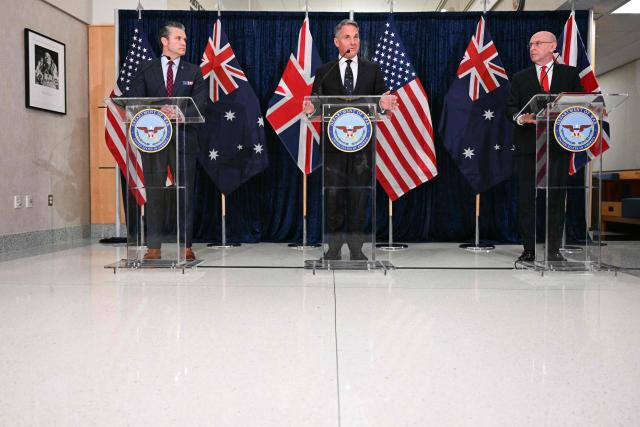 (L/R) US Secretary of Defense Pete Hegseth, Australian Deputy Prime Minister and Defense Minister Richard Marles, and Britain's Defence Secretary John Healey deliver remarks during the annual AUKUS Defense Ministers' Ministerial at the Pentagon in Washington, DC, on December 10, 2025. (Photo by Jim WATSON / AFP)