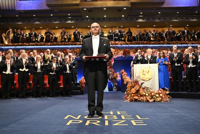 Nobel Prize in Chemistry 2025 laureate US-Jordanian chemist Omar M. Yaghi poses with his award during the award ceremony on December 10, 2025 in Stockholm, Sweden. The laureates received their prizes at formal ceremonies in Stockholm and Oslo on December 10. That date is the anniversary of the death in 1896 of scientist Alfred Nobel, who created the prizes in his will. (Photo by Henrik Montgomery/TT / TT NEWS AGENCY / AFP) / Sweden OUT