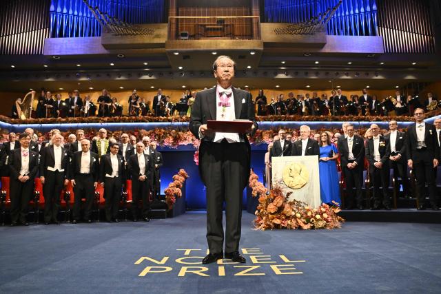 Nobel Prize in Chemistry 2025 laureate Japanese chemist Susumu Kitagawa poses with his award during the award ceremony on December 10, 2025 in Stockholm, Sweden. The laureates received their prizes at formal ceremonies in Stockholm and Oslo on December 10. That date is the anniversary of the death in 1896 of scientist Alfred Nobel, who created the prizes in his will. (Photo by Henrik Montgomery/TT / TT NEWS AGENCY / AFP) / Sweden OUT