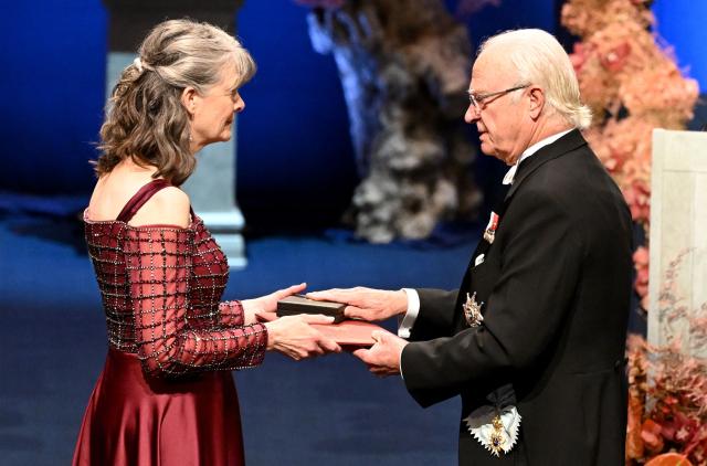 King Carl XVI Gustaf of Sweden (R) hands over the award to Nobel Prize in Physiology or Medicine 2025 laureate US molecular biologist and immunologist Mary E Brunkow during the Nobel Prize award ceremony on December 10, 2025 in Stockholm, Sweden. The laureates will receive their prizes at formal ceremonies in Stockholm and Oslo on December 10. That date is the anniversary of the death in 1896 of scientist Alfred Nobel, who created the prizes in his will. (Photo by Jonathan Nackstrand / AFP)