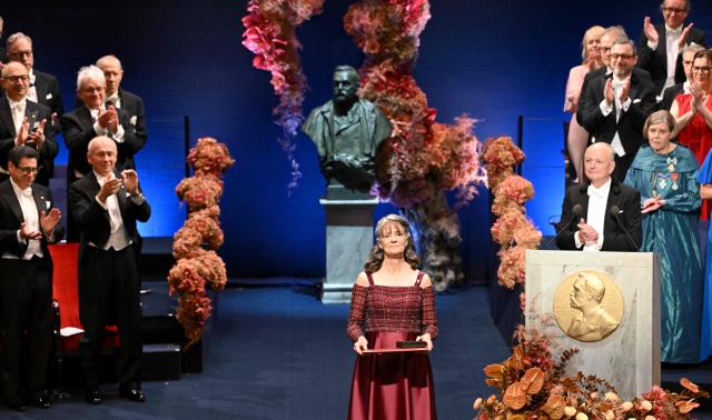 Nobel Prize in Physiology or Medicine 2025 laureate US molecular biologist and immunologist Mary E Brunkow poses with her award during the Nobel Prize award ceremony on December 10, 2025 in Stockholm, Sweden. The laureates will receive their prizes at formal ceremonies in Stockholm and Oslo on December 10. That date is the anniversary of the death in 1896 of scientist Alfred Nobel, who created the prizes in his will. (Photo by Jonathan Nackstrand / AFP)