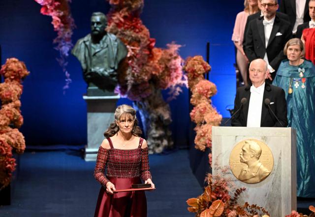 Nobel Prize in Physiology or Medicine 2025 laureate US molecular biologist and immunologist Mary E Brunkow poses with her award during the Nobel Prize award ceremony on December 10, 2025 in Stockholm, Sweden. The laureates will receive their prizes at formal ceremonies in Stockholm and Oslo on December 10. That date is the anniversary of the death in 1896 of scientist Alfred Nobel, who created the prizes in his will. (Photo by Jonathan Nackstrand / AFP)