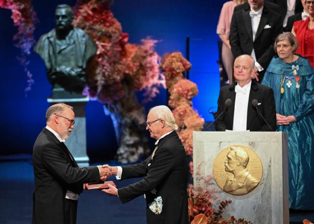 Nobel Prize in Physiology or Medicine 2025 laureate US immunologist Fred Ramsdell is handed his award by King Carl XVI Gustaf of Sweden (R) during the 2025 Nobel Prize award ceremony on December 10, 2025 in Stockholm, Sweden. The laureates received their prizes at formal ceremonies in Stockholm and Oslo on December 10. That date is the anniversary of the death in 1896 of scientist Alfred Nobel, who created the prizes in his will. (Photo by Jonathan Nackstrand / AFP)