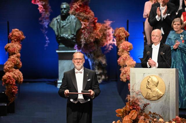 Nobel Prize in Physiology or Medicine 2025 laureate US immunologist Fred Ramsdell poses on stage with his award during the 2025 Nobel Prize award ceremony on December 10, 2025 in Stockholm, Sweden. The laureates received their prizes at formal ceremonies in Stockholm and Oslo on December 10. That date is the anniversary of the death in 1896 of scientist Alfred Nobel, who created the prizes in his will. (Photo by Jonathan Nackstrand / AFP)