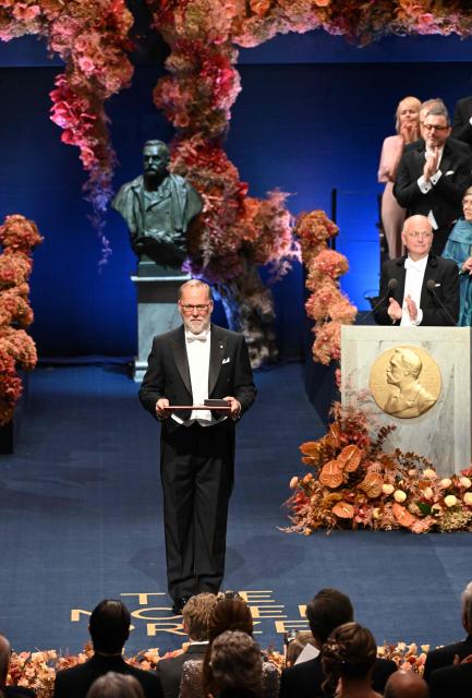Nobel Prize in Physiology or Medicine 2025 laureate US immunologist Fred Ramsdell poses on stage with his award during the 2025 Nobel Prize award ceremony on December 10, 2025 in Stockholm, Sweden. The laureates received their prizes at formal ceremonies in Stockholm and Oslo on December 10. That date is the anniversary of the death in 1896 of scientist Alfred Nobel, who created the prizes in his will. (Photo by Jonathan Nackstrand / AFP)