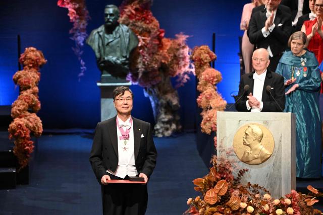 Nobel Prize in Physiology or Medicine 2025 laureate Japanese immunologist Shimon Sakaguchi poses with his award during the Nobel award ceremony at the Concert Hall in Stockholm, Sweden on December 10, 2025. The laureates received their prizes at formal ceremonies in Stockholm and Oslo on December 10. That date is the anniversary of the death in 1896 of scientist Alfred Nobel, who created the prizes in his will. (Photo by Jonathan Nackstrand / AFP)