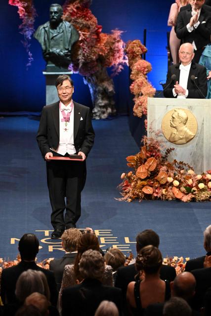 Nobel Prize in Physiology or Medicine 2025 laureate Japanese immunologist Shimon Sakaguchi is handed his award by King Carl XVI Gustaf of Sweden (R) during the Nobel award ceremony at the Concert Hall in Stockholm, Sweden on December 10, 2025. The laureates received their prizes at formal ceremonies in Stockholm and Oslo on December 10. That date is the anniversary of the death in 1896 of scientist Alfred Nobel, who created the prizes in his will. (Photo by Jonathan Nackstrand / AFP)