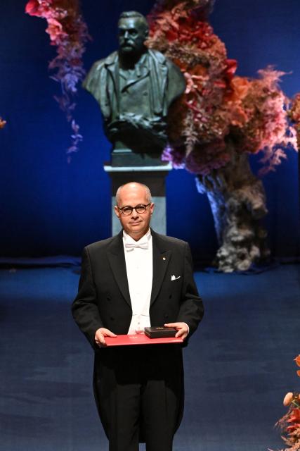Nobel Prize in Chemistry 2025 laureate US-Jordanian chemist Omar M. Yaghi poses with his award during the award ceremony on December 10, 2025 in Stockholm, Sweden. The laureates received their prizes at formal ceremonies in Stockholm and Oslo on December 10. That date is the anniversary of the death in 1896 of scientist Alfred Nobel, who created the prizes in his will. (Photo by Jonathan Nackstrand / AFP)