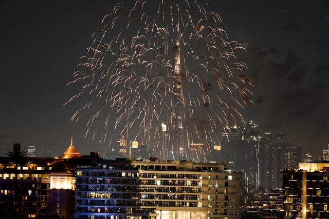 Fireworks displayed near the Burj Khalifa, the world’s tallest building, in the Dubai on December 10, 2025. (Photo by FADEL SENNA / AFP)