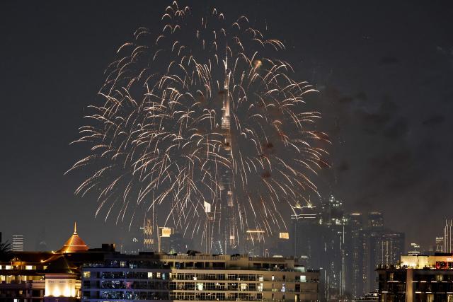 Fireworks displayed near the Burj Khalifa, the world’s tallest building, in the Dubai on December 10, 2025. (Photo by FADEL SENNA / AFP)