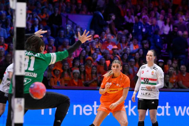 Netherlands' right wing #26 Angela Malestein (C) shoots to score during the quarter finals match between the Netherlands and Hungary of the IHF Women's Handball World Championship in Rotterdam Ahoy, in Rotterdam on December 10, 2025. (Photo by JOHN THYS / AFP)