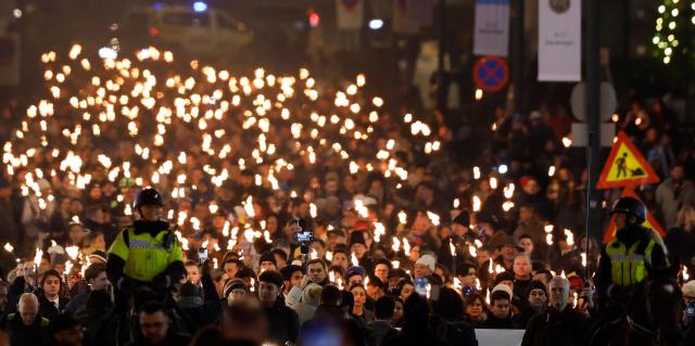 The Norwegian Venezuelan Justice Alliance and other people take part in a torchlight procession in honor of Nobel Peace Prize laureate Maria Corina Machado in Oslo, Norway, on December 10, 2025. The daughter of the Nobel Peace Prize laureate, Ana Corina Sosa, accepted the award on behalf of her mother during a ceremony at Oslo City Hall. Venezuelan opposition leader Maria Corina Machado received the award for her tireless work to secure democratic rights for the people of Venezuela, and for her fight for a just and peaceful transition from dictatorship to popular rule. Due to the circumstances in her home country of Venezuela, the Nobel Peace Prize laureate was unable to attend the award ceremony in Norway. (Photo by Odd ANDERSEN / AFP) / Norway OUT