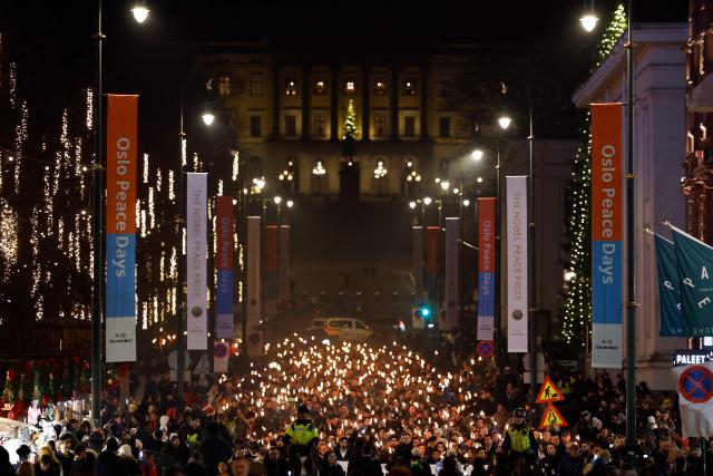 The Norwegian Venezuelan Justice Alliance is organizing a torchlight procession in honor of Nobel Peace Prize laureate Maria Corina Machado in Oslo, Norway, on December 10, 2025. The daughter of the Nobel Peace Prize laureate, Ana Corina Sosa, accepted the award on behalf of her mother during a ceremony at Oslo City Hall. Venezuelan opposition leader Maria Corina Machado received the award for her tireless work to secure democratic rights for the people of Venezuela, and for her fight for a just and peaceful transition from dictatorship to popular rule. Due to the circumstances in her home country of Venezuela, the Nobel Peace Prize laureate was unable to attend the award ceremony in Norway. (Photo by Odd ANDERSEN / AFP) / Norway OUT
