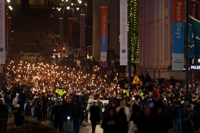 The Norwegian Venezuelan Justice Alliance and other people take part in a torchlight procession in honor of Nobel Peace Prize laureate Maria Corina Machado in Oslo, Norway, on December 10, 2025. The daughter of the Nobel Peace Prize laureate, Ana Corina Sosa, accepted the award on behalf of her mother during a ceremony at Oslo City Hall. Venezuelan opposition leader Maria Corina Machado received the award for her tireless work to secure democratic rights for the people of Venezuela, and for her fight for a just and peaceful transition from dictatorship to popular rule. Due to the circumstances in her home country of Venezuela, the Nobel Peace Prize laureate was unable to attend the award ceremony in Norway. (Photo by Odd ANDERSEN / AFP) / Norway OUT