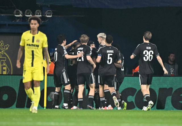 FC Copenhagen's Norwegian forward #10 Mohamed Elyounoussi celebrates scoring his team's first goal with teammates during the UEFA Champions League league phase day 6 football match between Villarreal CF and FC Copenhagen at La Ceramica Stadium in Vila-real on December 10, 2025. (Photo by JOSE JORDAN / AFP)