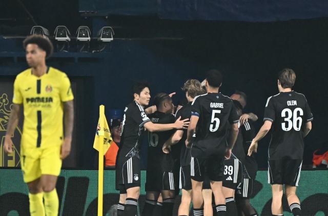 FC Copenhagen's Norwegian forward #10 Mohamed Elyounoussi celebrates scoring his team's first goal with teammates during the UEFA Champions League league phase day 6 football match between Villarreal CF and FC Copenhagen at La Ceramica Stadium in Vila-real on December 10, 2025. (Photo by JOSE JORDAN / AFP)
