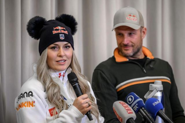 US Lindsey Vonn (L) speaks next to her coach former Norwegian skier Aksel Lund Svindal, during a press conference ahead of speed ski races as part of the FIS Alpine ski World Cup 2025-2026, in St. Moritz on December 10, 2025. (Photo by Fabrice COFFRINI / AFP)