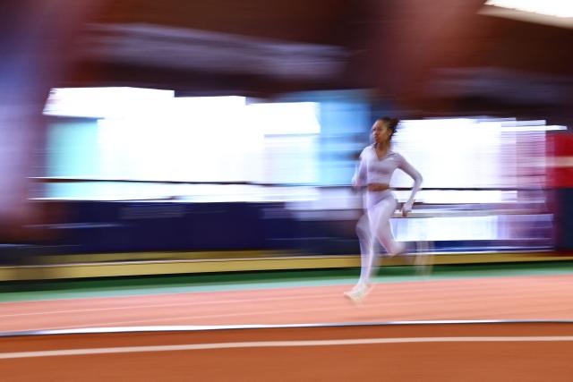 TOPSHOT - French sprinter Pamera Losange, deaf since birth and the French Elite 200m champion among able-bodied athletes, runs during a training session at France’s National Institute of Sport, Expertise, and Performance (INSEP) after winning two gold medals at the recent Tokyo 2025 Deaflympics (the Olympic Games for deaf and hard-of-hearing athletes), in Paris on December 10, 2025. (Photo by Anne-Christine POUJOULAT / AFP)