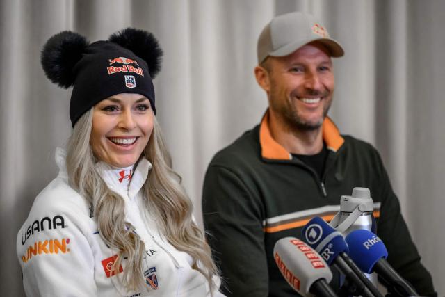 US Lindsey Vonn (L) smiles next to her coach former Norwegian skier Aksel Lund Svindal, during a press conference ahead of speed ski races as part of the FIS Alpine ski World Cup 2025-2026, in St. Moritz on December 10, 2025. (Photo by Fabrice COFFRINI / AFP)