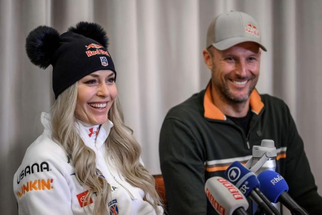 US Lindsey Vonn (L) speaks next to her coach former Norwegian skier Aksel Lund Svindal, during a press conference ahead of speed ski races as part of the FIS Alpine ski World Cup 2025-2026, in St. Moritz on December 10, 2025. (Photo by Fabrice COFFRINI / AFP)
