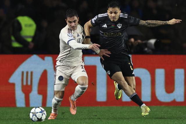 Ajax's Brazilian defender #02 Lucas Rosa and Qarabag's Brazilian defender #02 Matheus de Barros da Silva vie for the ball during the UEFA Champions League league phase football match between Qarabag and Ajax at the Tofiq Bahramov Republican Stadium in Baku on December 10, 2025. (Photo by Giorgi ARJEVANIDZE / AFP)