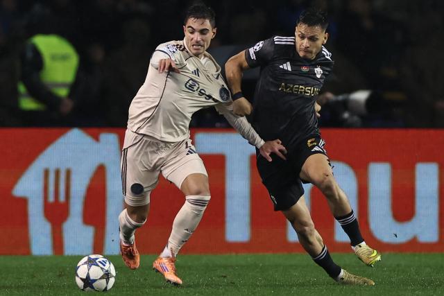 Ajax's Brazilian defender #02 Lucas Rosa and Qarabag's Brazilian defender #02 Matheus de Barros da Silva vie for the ball during the UEFA Champions League league phase football match between Qarabag and Ajax at the Tofiq Bahramov Republican Stadium in Baku on December 10, 2025. (Photo by Giorgi ARJEVANIDZE / AFP)