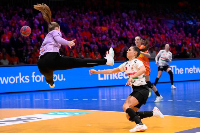Hungary's left wing #09 Julia Harsfalvi (C) shoots during the quarter finals match between the Netherlands and Hungary of the IHF Women's Handball World Championship in Rotterdam Ahoy, in Rotterdam on December 10, 2025. (Photo by JOHN THYS / AFP)