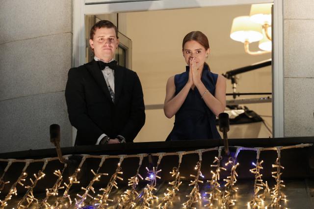 Ana Corina Sosa, the daughter of Venezuelan opposition leader and laureate of the Nobel Peace Prize Maria Corina Machado (unseen), reacts near he son Ricardo Sosa Machado (L) from the balcony of the Grand Hotel during the torchlight procession in Oslo, Norway, on December 10, 2025. The 2025 Nobel Peace Prize was awarded to Maria Corina Machado for her efforts to bring democracy to Venezuela, challenging the iron-fisted rule of Venezuelan President Nicolas Maduro, who has been president since 2013. Her daughter Maria Corina Machado had accepted the prize in her absence in Oslo. (Photo by Amanda Pedersen Giske / NTB / AFP) / Norway OUT