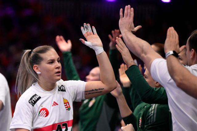 Hungary's right back #42 Katrin Klujber (L) celebrates after scoring during the quarter finals match between the Netherlands and Hungary of the IHF Women's Handball World Championship in Rotterdam Ahoy, in Rotterdam on December 10, 2025. (Photo by JOHN THYS / AFP)