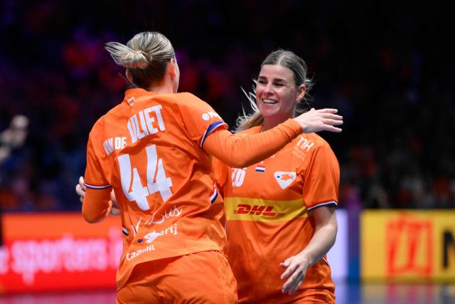 Netherlands' pivot #44 Nikita van der Vliet (L) celebrates with Netherlands' right wing #26 Angela Malestein after scoring during the quarter finals match between the Netherlands and Hungary of the IHF Women's Handball World Championship in Rotterdam Ahoy, in Rotterdam on December 10, 2025. (Photo by JOHN THYS / AFP)
