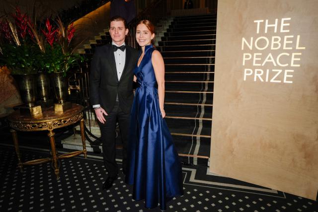 Ana Corina Sosa, the daughter of Venezuelan opposition leader and laureate of the Nobel Peace Prize Maria Corina Machado (unseen), and her son Ricardo Sosa Machado (L) arrive for the Nobel Peace Award banquet at the Grand Hotel in Oslo, Norway, on December 10, 2025. The 2025 Nobel Peace Prize was awarded to Maria Corina Machado for her efforts to bring democracy to Venezuela, challenging the iron-fisted rule of Venezuelan President Nicolas Maduro, who has been president since 2013. Her daughter Maria Corina Machado had accepted the prize in her absence in Oslo. (Photo by Lise Åserud / NTB / AFP) / Norway OUT