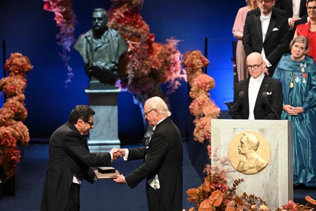 The laureate of The Sveriges Riksbank Prize in Economic Sciences 2025 French economist Philippe Aghion is handed his award by King Carl XVI Gustaf of Sweden (R) during the 2025 Nobel Prize award ceremony on December 10, 2025 in Stockholm, Sweden. The laureates received their prizes at formal ceremonies in Stockholm and Oslo on December 10. That date is the anniversary of the death in 1896 of scientist Alfred Nobel, who created the prizes in his will. (Photo by Jonathan Nackstrand / AFP) / Sweden OUT