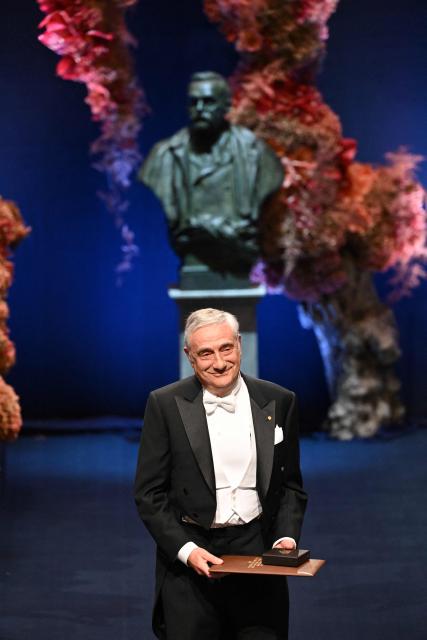 Laureate of The Sveriges Riksbank Prize in Economic Sciences 2025 US-Israeli economic historian Joel Mokyr poses with his award during the Nobel award ceremony at the Concert Hall in Stockholm, Sweden on December 10, 2025. The laureates received their prizes at formal ceremonies in Stockholm and Oslo on December 10. That date is the anniversary of the death in 1896 of scientist Alfred Nobel, who created the prizes in his will. (Photo by Jonathan Nackstrand / AFP)