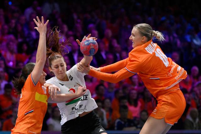 Hungary's right back #11 Anna Albek (C) tries to shoot during the quarter finals match between the Netherlands and Hungary of the IHF Women's Handball World Championship in Rotterdam Ahoy, in Rotterdam on December 10, 2025. (Photo by JOHN THYS / AFP)