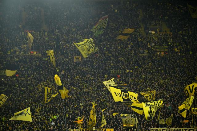 BVB Borussia Dortmund's fans cheer for their team prior to the UEFA Champions League league phase day 6 football match between Borussia Dortmund and Bodoe/Glimt in Dortmund, western Germany, on December 10, 2025. (Photo by INA FASSBENDER / AFP)