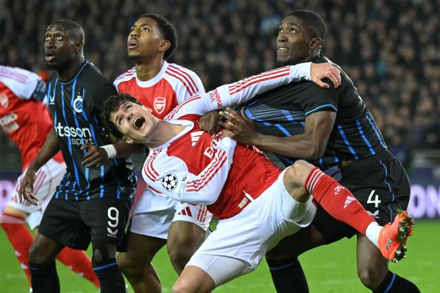 Arsenal's Danish midfielder #16 Christian Norgaard (C) and Club Brugge's Ecuadorian defender #04 Joel Ordonez (R) fight for position off the ball during the UEFA Champions League, league phase - matchday 6, football match between Club Brugge and Arsenal at the Jan Breydel stadium in Bruges on December 10, 2025. (Photo by NICOLAS TUCAT / AFP)