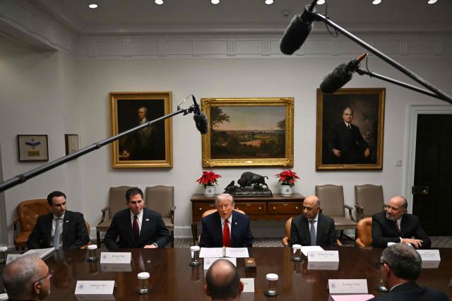 US President Donald Trump (C) speaks, flanked by (R/L) US Secretary of Commerce Howard Lutnick, CEO of IBM Arvind Krishna and CEO of Dell Technologies Michael Dell, during a roundtable discussion in the Roosevelt Room of the White House in Washington, DC, on December 10, 2025. (Photo by ANDREW CABALLERO-REYNOLDS / AFP)