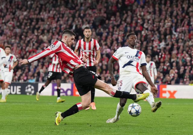 Athletic Bilbao's Spanish midfielder #08 Oihan Sancet fights for the ball with Paris Saint-Germain's French midfielder #24 Senny Mayulu during the UEFA Champions League league phase day 6 football match between Athletic Club Bilbao and Paris Saint-Germain (PSG) at San Mames Stadium in Bilbao on December 10, 2025. (Photo by Cesar MANSO / AFP)