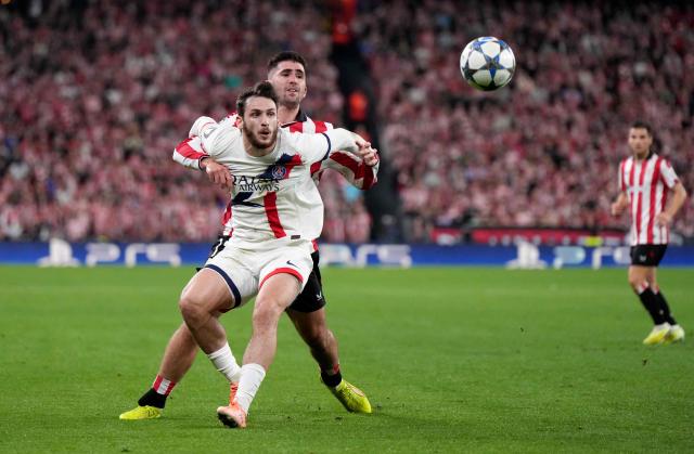 Paris Saint-Germain's Georgian forward #07 Khvicha Kvaratskhelia fights for the ball with Athletic Bilbao's Spanish defender #12 Jesus Areso Blanco during the UEFA Champions League league phase day 6 football match between Athletic Club Bilbao and Paris Saint-Germain (PSG) at San Mames Stadium in Bilbao on December 10, 2025. (Photo by Cesar MANSO / AFP)