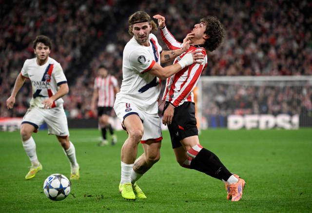 TOPSHOT - Paris Saint-Germain's Ukrainian defender #06 Illia Zabarnyi fights for the ball with Athletic Bilbao's Spanish midfielder #20 Unai Gomez during the UEFA Champions League league phase day 6 football match between Athletic Club Bilbao and Paris Saint-Germain (PSG) at San Mames Stadium in Bilbao on December 10, 2025. (Photo by ANDER GILLENEA / AFP)