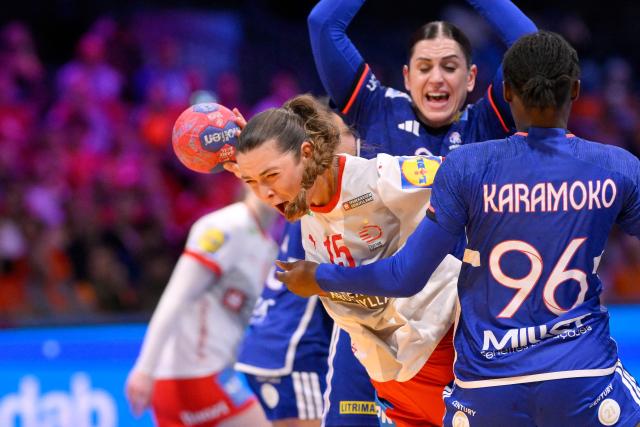 Denmark's pivot #15 Sofie Bardrum-Larsen is challenged by France's players during the quarter finals match between Denmark and France of the IHF Women's Handball World Championship in Rotterdam Ahoy, in Rotterdam on December 10, 2025. (Photo by JOHN THYS / AFP)