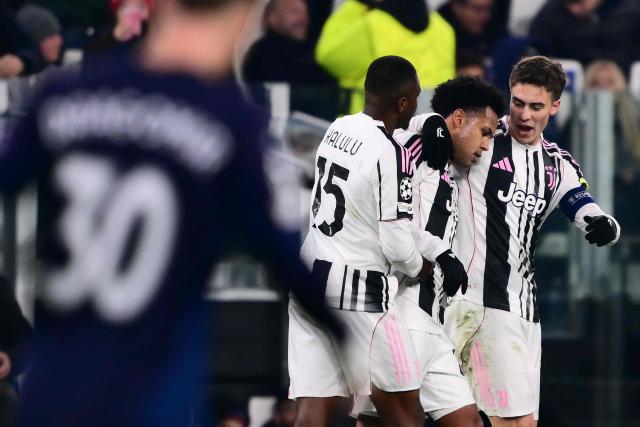 Juventus' US midfielder #22 Weston McKennie (C) celebrates scoring his team's first goal with Juventus' French defender #15 Pierre Kalulu Kyatengwa (L) and Juventus' Turkish forward #10 Kenan Yildiz during the UEFA Champions League - league phase day 6 football match between Juventus and Pafos FC at the Allianz stadium in Turin, on December 10, 2025. (Photo by Marco BERTORELLO / AFP)