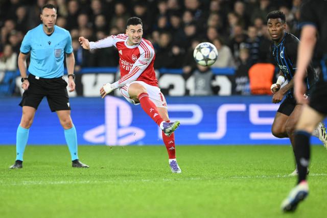 Arsenal's Brazilian forward #11 Gabriel Martinelli (C) shoots to score Arsenal's third goal during the UEFA Champions League, league phase - matchday 6, football match between Club Brugge and Arsenal at the Jan Breydel stadium in Bruges on December 10, 2025. (Photo by NICOLAS TUCAT / AFP)