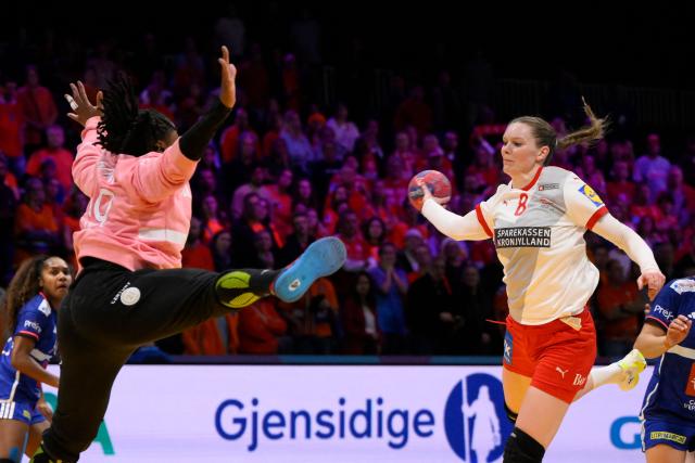 Denmark's left back #08 Anne Mette Hansen (R) shoots during the quarter finals match between Denmark and France of the IHF Women's Handball World Championship in Rotterdam Ahoy, in Rotterdam on December 10, 2025. (Photo by JOHN THYS / AFP)
